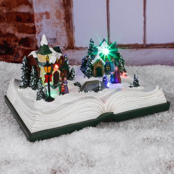 Osvětlená vánoční vesnička na knize