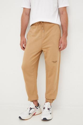 Bavlněné tepláky Calvin Klein Jeans hnědá barva, s potiskem